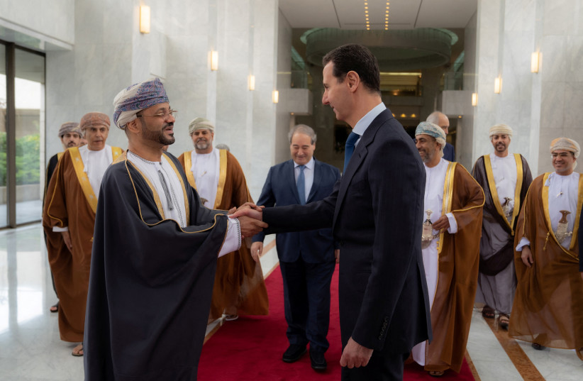  Syria's President Bashar al-Assad welcomes Oman's Foreign Minister Badr Al Busaidi in Damascus, Syria, in this handout released by SANA on January 31, 2022.  (photo credit: SANA/REUTERS)