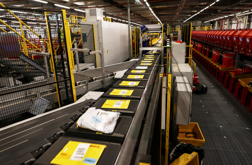 Packages are sorted at a DHL robotic package processing site, which the company claims is the largest and most advanced of its kind in the Middle East, in Lod, Israel, January 11, 2022. (credit: REUTERS/Ronen Zvulun)