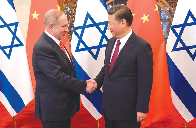  THEN-PRIME MINISTER Benjamin Netanyahu and Chinese President Xi Jinping shake hands ahead of talks in Beijing in 2017. The two leaders categorized the bilateral ties as a Comprehensive Innovation Partnership. (photo credit: Etienne Oliveau/Reuters)