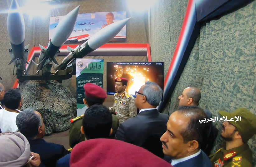  HOUTHI OFFICIALS gather around surface-to-air missiles on display, during an exhibition in an unidentified location in Yemen, in this undated photo released by the Houthi Media Office in Feb. 2020. (photo credit: HOUTHI MEDIA OFFICE/HANDOUT VIA REUTERS)