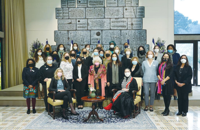  MASKED DIPLOMATIC spouses pose with Michal Herzog.   (credit: Spoksperson’s unit, President’s Office)