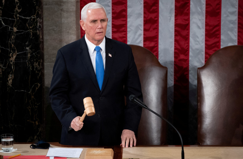 US Vice President Mike Pence officiates as a joint session of the House and Senate convenes to confirm the Electoral College votes cast in November's election, at the Capitol in Washington, US, January 6, 2021. (photo credit: SAUL LOEB/POOL VIA REUTERS/FILE PHOTO)