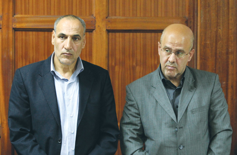 SAYED MOUSAVI (left) and Ahmad Mohammed stand during sentencing at the Kenyan High Court in Nairobi in May 2013. They received life sentences for planning bombing attacks the previous year.  (photo credit: NOOR KHAMIS/REUTERS)