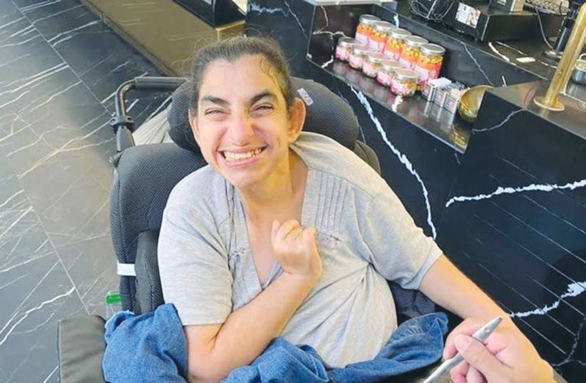  AN ADI resident with severe disabilities enjoys a sweet treat at an Israeli ice cream parlor. (photo credit: ADI)