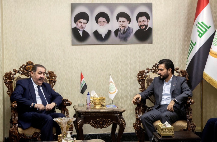 Hassan Al-Adari, head of the political body of the Sadrist bloc, meets with Hoshyar Zebari, head of the Kurdish delegation, for negotiations on forming the new government after the parliamentary elections, in Baghdad, Iraq, November 5, 2021.  (photo credit: HADI MIZBAN/REUTERS)