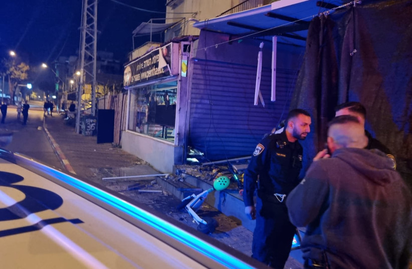 Police at the scene of a grenade attack on a grocery store in Petah Tikva, Israel, February 7, 2022. (photo credit: COURTESY)