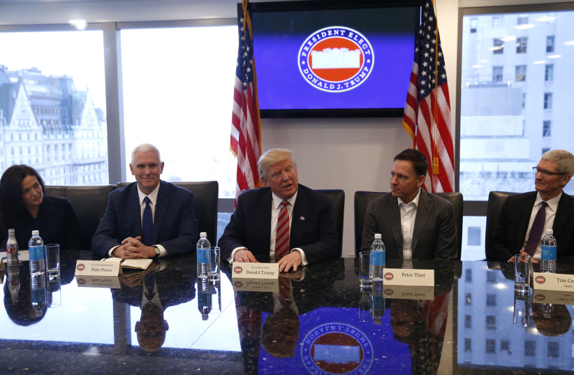  US President-elect Donald Trump (C) sits with Vice President-elect Mike Pence (2ndL) PayPal co-founder and Facebook board member Peter Thiel (2ndR), Apple Inc CEO Tim Cook (R) and Facebook COO Sheryl Sandberg during a meeting with technology leaders at Trump Tower in NY, US., December 14, 2016. (credit: SHANNON STAPLETON/ REUTERS)