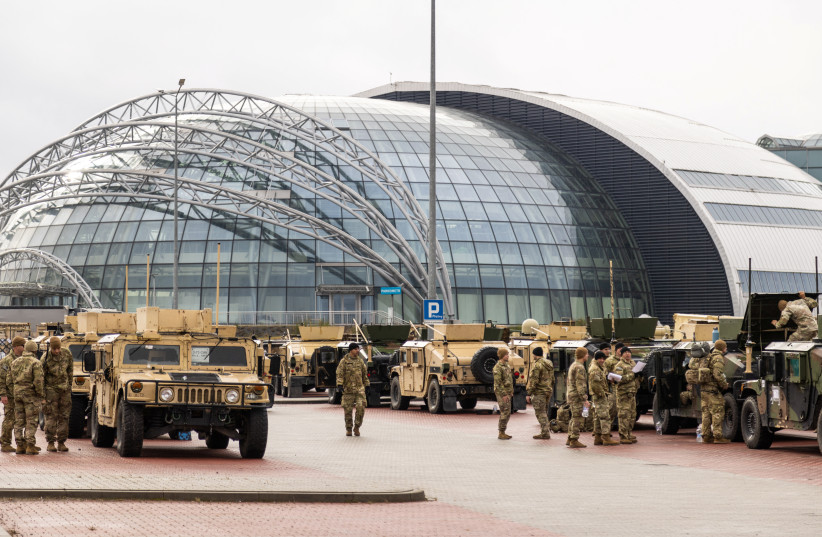 US military Humvees (High Mobility Multipurpose Wheeled Vehicle) are parked outisde the G2A Arena near the Rzeszow-Jasionka Airport, in Jasionka, Poland, February 9, 2022. (credit: REUTERS/KUBA STEZYCKI)