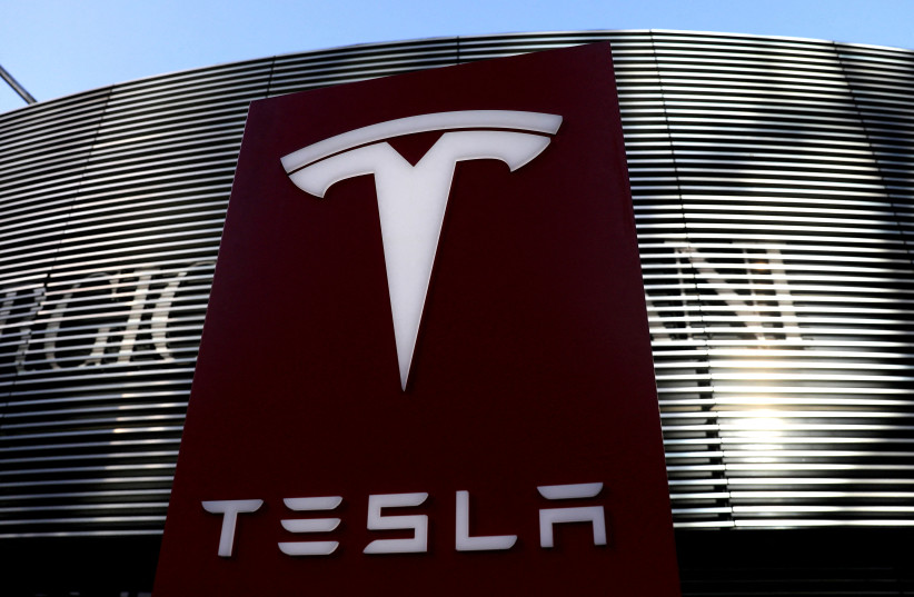  A logo of the electric vehicle maker Tesla is seen near a shopping complex in Beijing, China January 5, 2021. (credit: REUTERS/TINGSHU WANG)