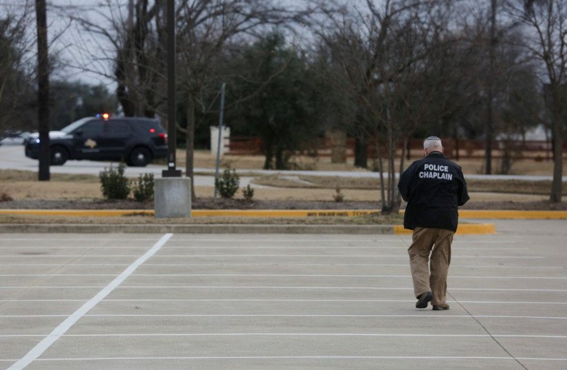  A police chaplain walks through the area where Malik Faisal Akram took Rabbi Charlie Cytron-Walker and three other congregants hostage during prayers at Congregation Beth Israel in Colleyville, Texas, on January 15. (credit: Shelby Tauber/Reuters)