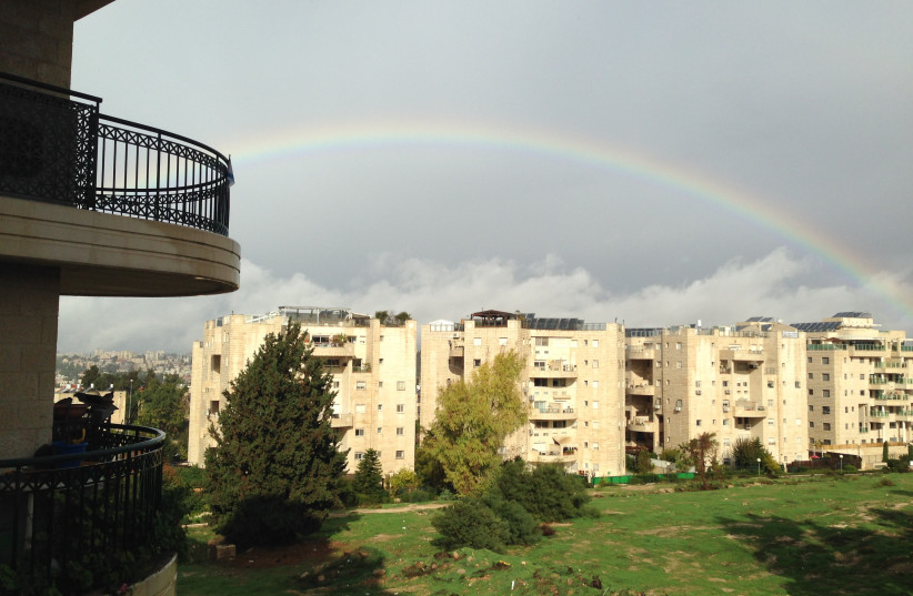  A rainbow over open land in the Jerusalem neighborhood of North Talpiot before it was turned into an apartment complex. (credit: ROBERT HERSOWITZ)