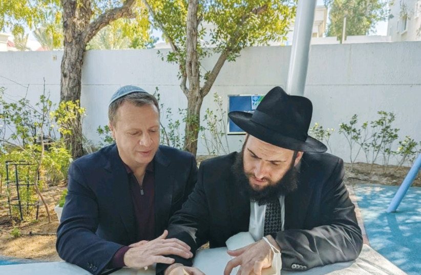  TOURISM MINISTER Yoel Razvozov with Rabbi Levi Duchman during the writing of an additional letter in the yet to be completed UAE Torah scroll. (photo credit: Courtesy JEWISH UAE)