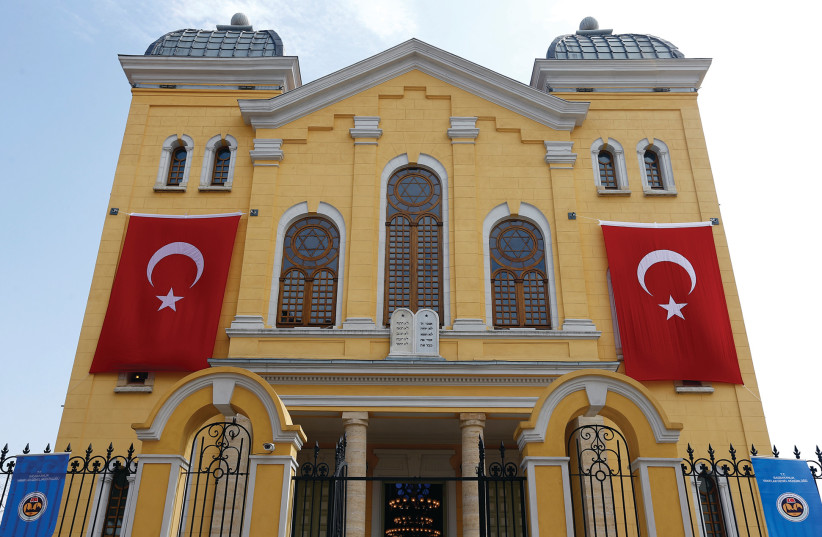  TURKISH FLAGS are seen on the facade of the restored Great Synagogue before a reopening ceremony in Edirne, western Turkey, in 2015.  (photo credit: MURAD SEZER/REUTERS)