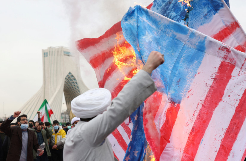  Iranian clerics set fire to American flag during the 43rd anniversary of the Islamic Revolution in Tehran, Iran, February 11, 2022.  (credit: MAJID ASGARIPOUR/WANA (WEST ASIA NEWS AGENCY) VIA REUTERS)