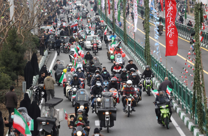 Iranians ride on motorcycles as they participate in the celebration of the 43rd anniversary of the Islamic Revolution in Tehran, Iran, February 11, 2022. (photo credit: MAJID ASGARIPOUR/WANA (WEST ASIA NEWS AGENCY) VIA REUTERS)