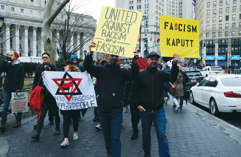  A COUNTER demonstration group protests in 2019 against Polish Americans holding a demonstration in Manhattan against a bill passed by the House of Representatives that supports victims of the Holocaust and their families in the process of restitution and recovery of property in New York City.  (photo credit: Spencer Platt/Getty Images)