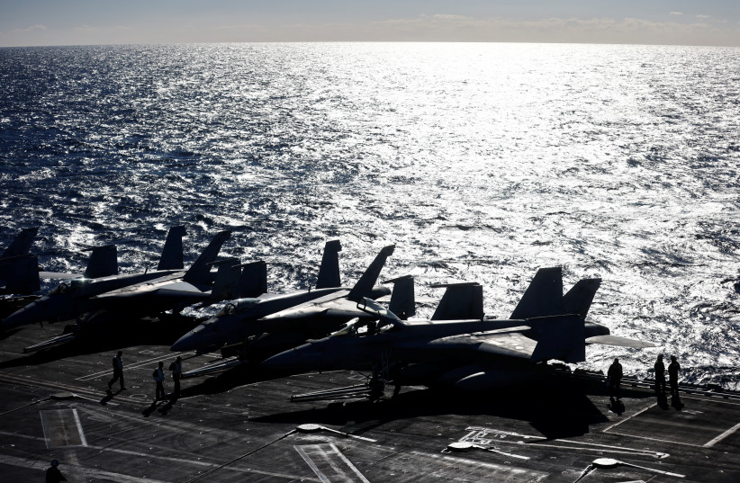  A military plane lands onboard aircraft carrier USS Harry S. Truman, in the Adriatic Sea, February 2, 2022. The Truman strike group is operating under NATO command and control along with several other NATO allies for coordinated maritime manoeuvres, anti-submarine warfare training and long-range tr (photo credit: REUTERS/YARA NARDI)