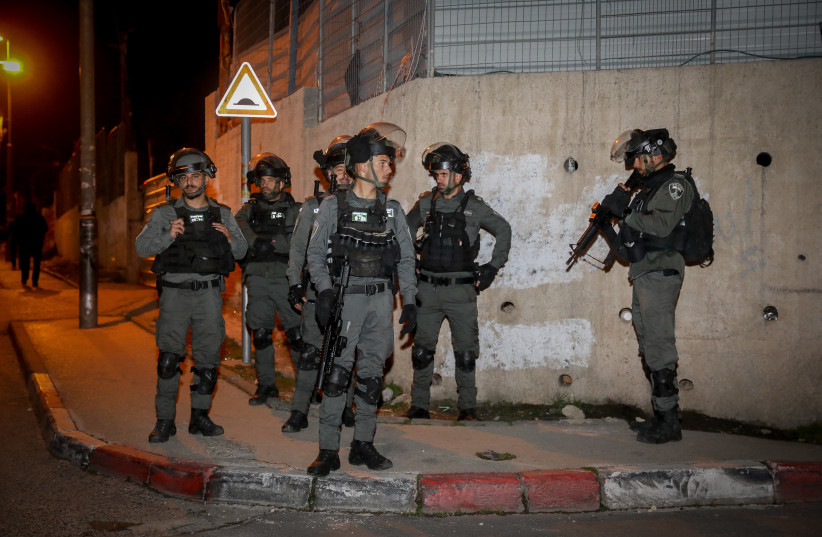  Israeli border police officers guard during riots in the East Jerusalem neighborhood of Sheikh Jarrah, February 13, 2022.  (credit: NOAM REVKIN FENTON/FLASH90)