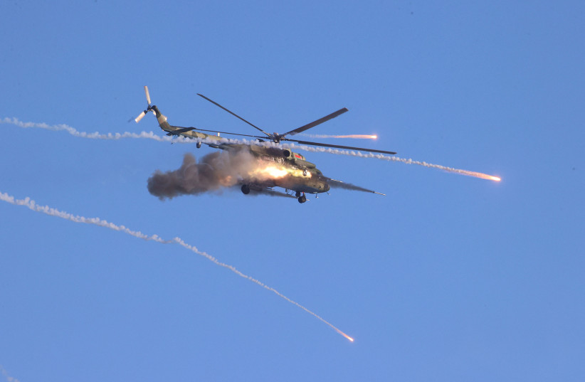  A helicopter fires during military exercises held by the armed forces of Russia and Belarus at the Gozhsky training ground in the Grodno region, Belarus, February 12, 2022.  (photo credit: LEONID SCHEGLOV/BELTA/HANDOUT VIA REUTERS)