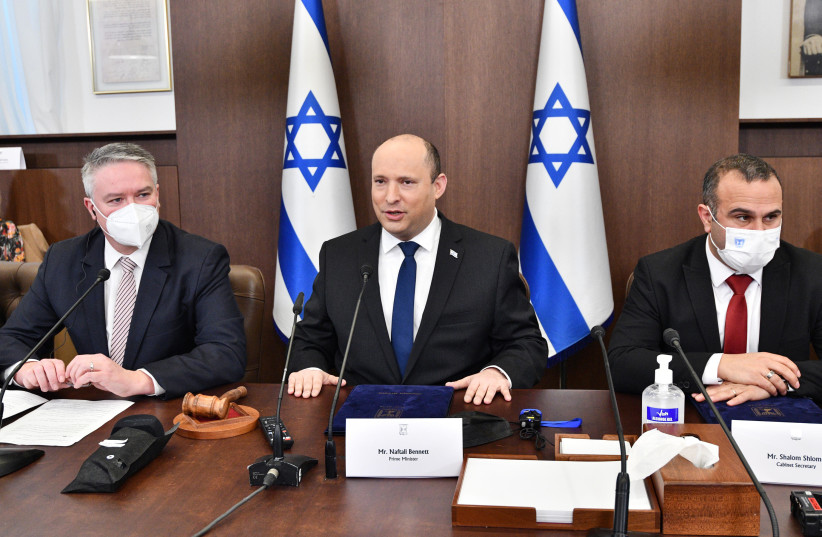  Secretary-General of the OECD Mathias Cormann and Prime Minister Naftali Bennett at a cabinet meeting on February 13, 2022. (credit: CHAIM TZACH/GPO)