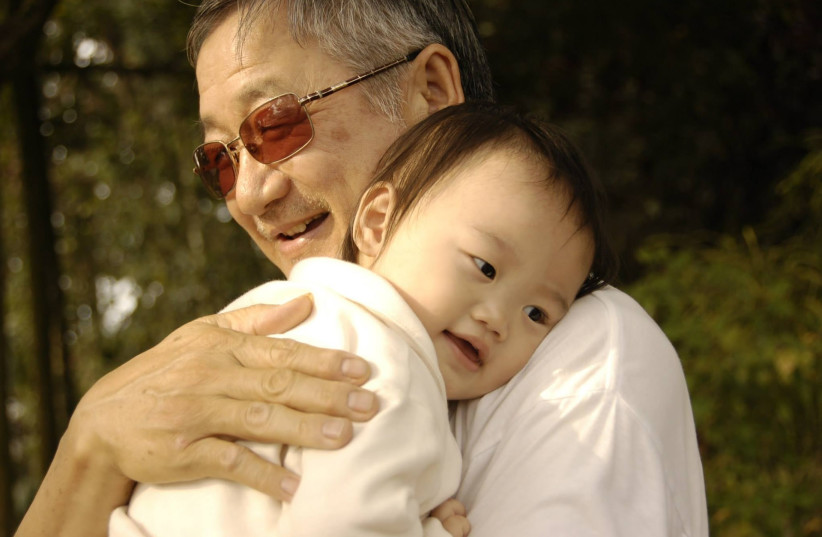  A grandfather hugs his grandchild, a young kid (Illustrative) (credit: PIXABAY)