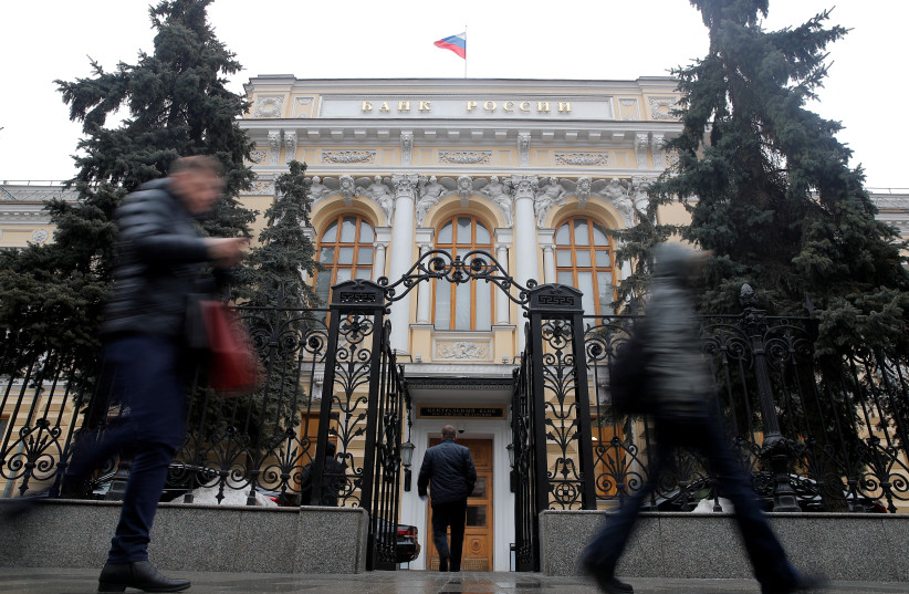  Maxim Shemetov People walk past the Central Bank headquarters in Moscow, Russia February 11, 2019. (photo credit: MAXIM SHEMETOV/REUTERS)