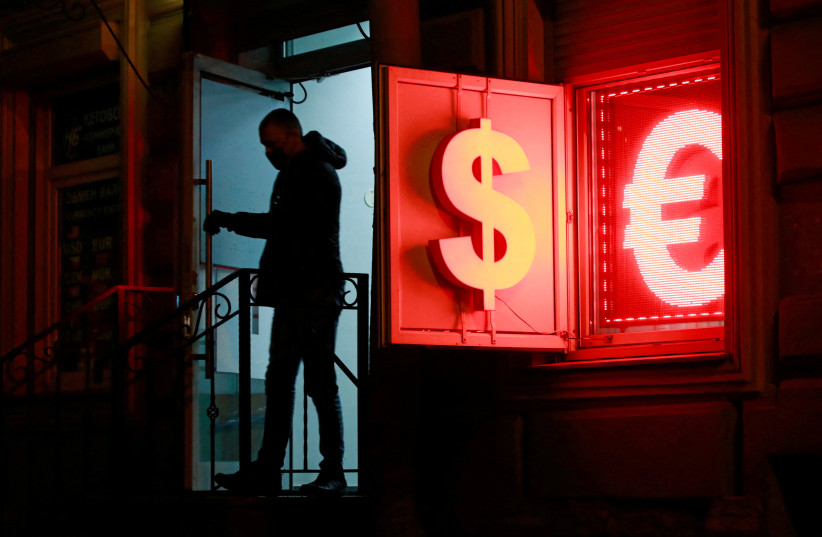  A man walks out of a currency exchange office in Saint Petersburg, Russia January 26, 2022.  (photo credit: ANTON VAGANOV/ REUTERS)