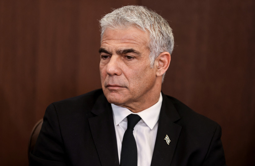  Israeli Foreign Minister Yair Lapid attends the weekly cabinet meeting at the prime minister's office in Jerusalem February 13, 2022.  (photo credit: MENAHEM KAHANA / REUTERS)