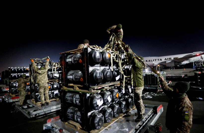 Ukrainian service members unpack Javelin anti-tank missiles, delivered by plane as part of the U.S. military support package for Ukraine, at the Boryspil International Airport outside Kyiv, Ukraine February 10, 2022 (photo credit: REUTERS/VALENTYN OGIRENKO)
