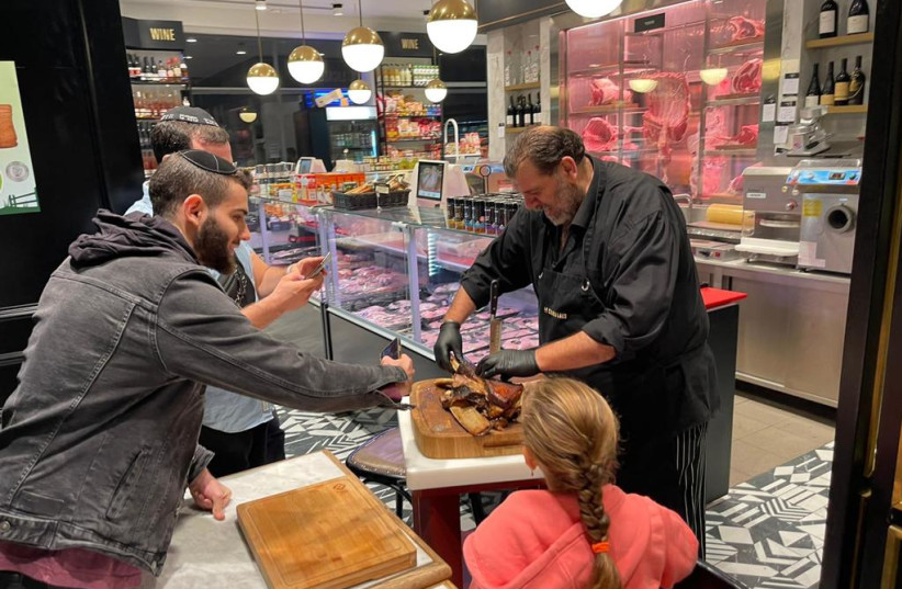  Marco Abutbul,  butcher and chef with more than fifty years of experience, serves a delectable gourmet dish to customers (photo credit: Courtesy)