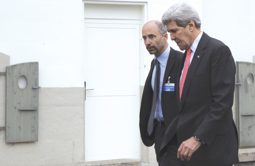  THEN-US secretary of state John Kerry walks with Robert Malley following a meeting with an Iranian team in 2015, before the Iran nuclear deal was reached.  (photo credit: BRIAN SNYDER/REUTERS)