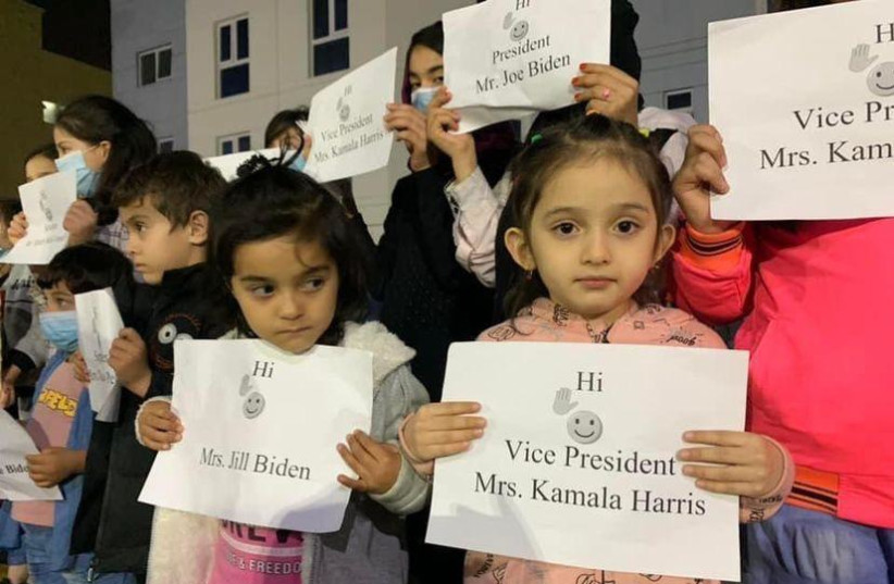  Afghan refugee children hold signs meant to grab the attention of the White House during this week's protests in Abu Dhabi (photo credit: FROM THE MEDIA LINE)