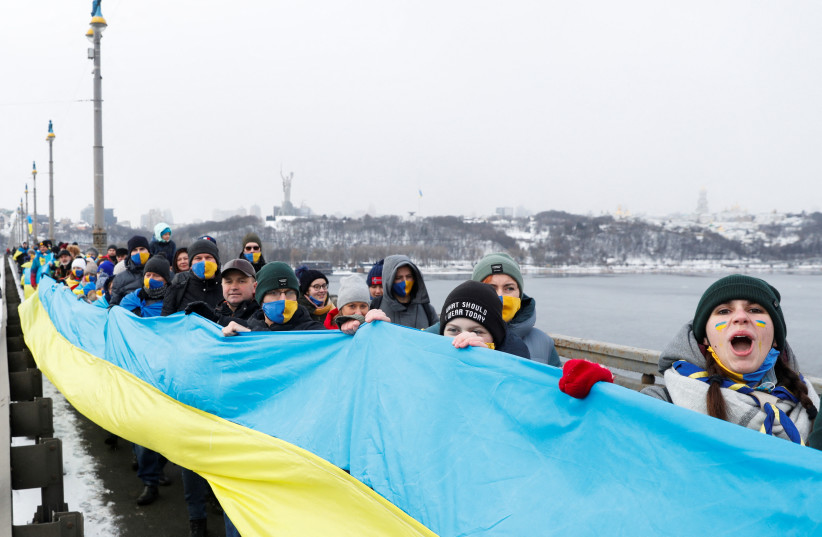 People form a human chain along a bridge across the Dnipro River as they celebrate the Day of Unity in Kyiv, Ukraine January 22, 2022. (photo credit: VALENTYN OGIRENKO/REUTERS)