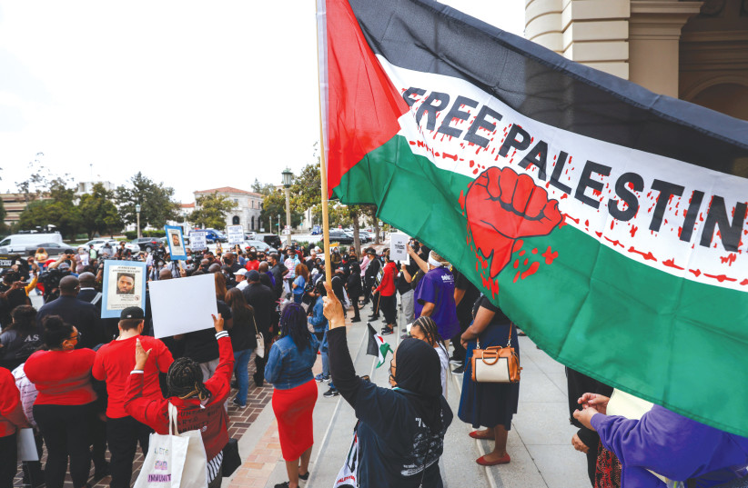  A DEMONSTRATOR holds a Free Palestine flag at a Black Lives Matter rally held in Pasadena, California, last year. (photo credit: CHRISTIAN MONTERROSA/REUTERS)