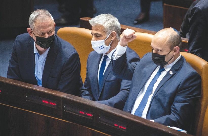  PRIME MINISTER Naftali Bennett, Foreign Minister Yair Lapid and Defense Minister Benny Gantz sit in the Knesset plenum during voting on the new draft legislation last month. (photo credit: FLASH90)