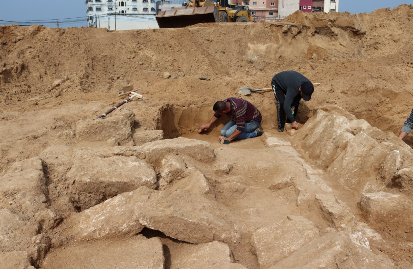 Men work in a newly discovered Roman cemetery in Gaza, in this handout photo obtained by Reuters, February 17, 2022. (credit: REUTERS)