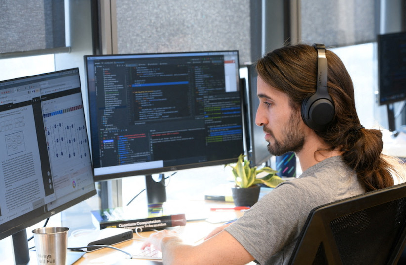  Yoni Zimmermann, a quantum software engineer at Classiq, a startup whose platform companies can use to build quantum applications on for the quantum computer, works on the software platform, in Tel Aviv, Israel, February 2022. (photo credit: Classiq/Handout via REUTERS)