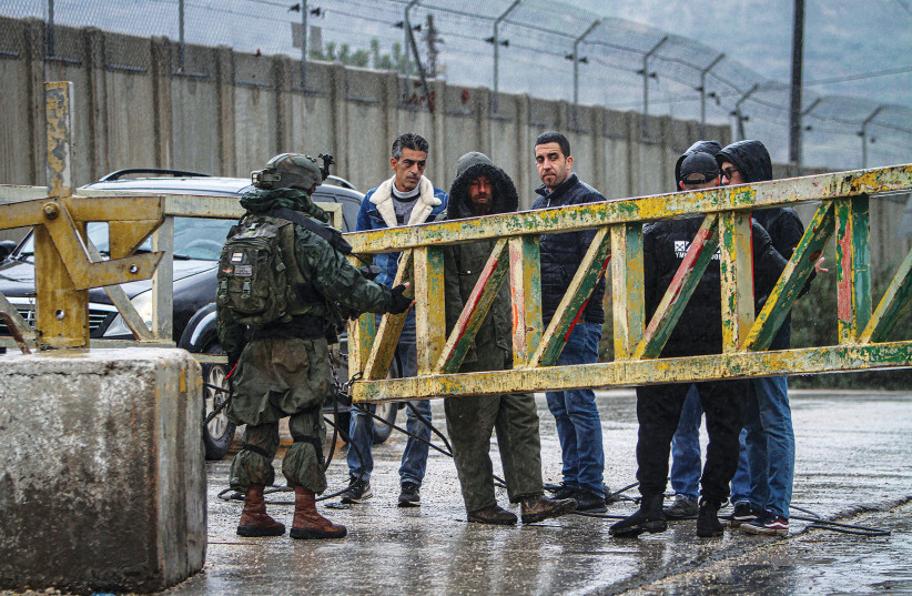  IDF SOLDIERS close a gate at the settlement of Shavei Shomron in the West Bank, near Nablus, last month.  (photo credit: NASSER ISHTAYEH/FLASH90)