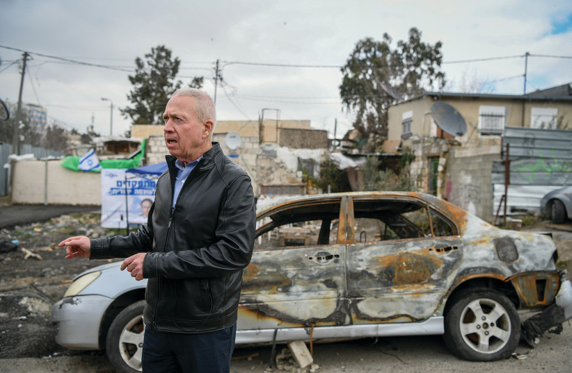  LIKUD MK Yoav Gallant in front of the Yoshubievs' torched car this week. (credit: ARIE LEIB ABRAMS/FLASH 90)