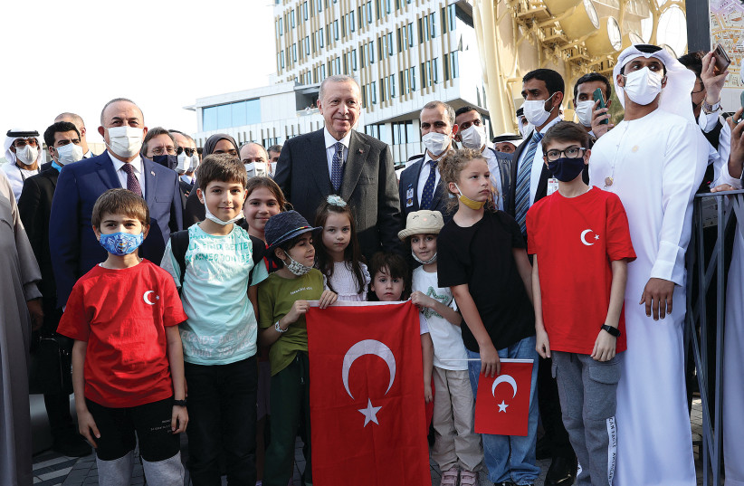  TURKISH PRESIDENT Recep Tayyip Erdogan poses with children as he visits the Turkish Pavilion of Expo 2020 in Dubai on Monday. (photo credit: PRESIDENTAL PRESS OFFICE)