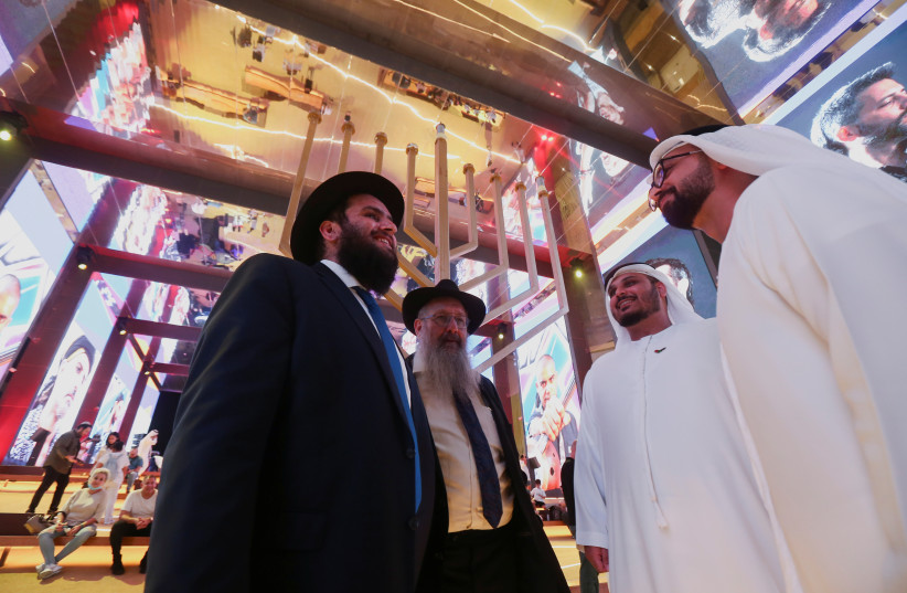 ocals talks to members of Jewish community as they gather to mark the festival of Hanukkah at the Israeli pavilion for Expo 2020 in Dubai, United Arab Emirates, November 28, 2021.  (photo credit: REUTERS/SATISH KUMAR)