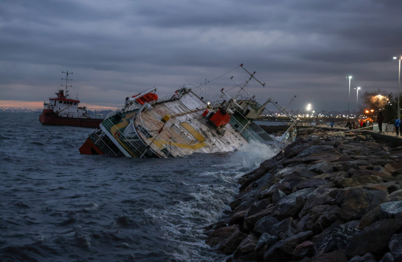  A ship is seen after it has been grounded on the shores of the Marmara Sea in Istanbul's Maltepe district after extreme winds drove it off its moorings in Istanbul, Turkey November 30, 2021 (photo credit: REUTERS/UMIT BEKTAS)