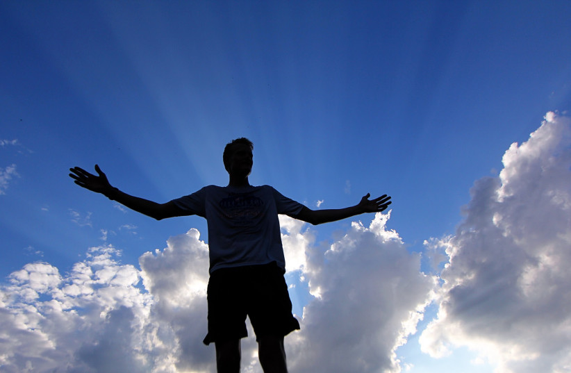  Man stands beneath the heavens. Does he hear the voice of God? (photo credit: PIXABAY)