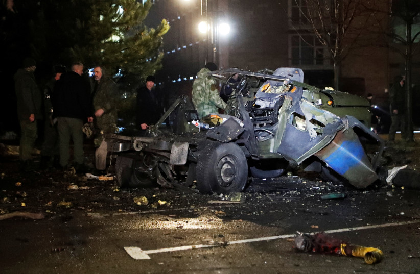 A view shows a wreckage of a car that, according to the local authorities, was blown up near the government building, in the rebel-controlled city of Donetsk, Ukraine, February 18, 2022. (photo credit: REUTERS/ALEXANDER ERMOCHENKO)