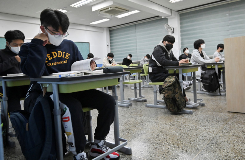  Students wait to take the annual College Scholastic Ability Test (CSAT), a nationwide university entrance exam, amid coronavirus disease (COVID-19) outbreak, at a school in Seoul, South Korea November 18, 2021. (photo credit: Jung Yeon-je/Pool via REUTERS)