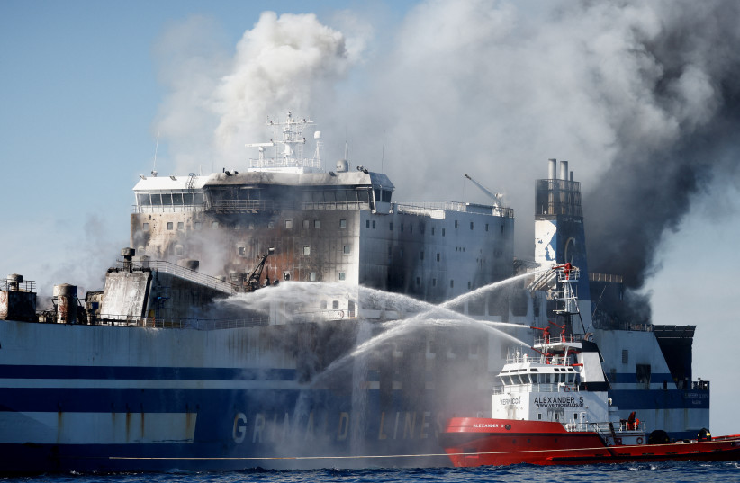  Smoke rises from the Italian-flagged Euroferry Olympia, which sailed from Greece to Italy early on Friday and caught fire, off the coast of Corfu, Greece, February 19, 2022. (photo credit: REUTERS/GUGLIELMO MANGIAPANE)