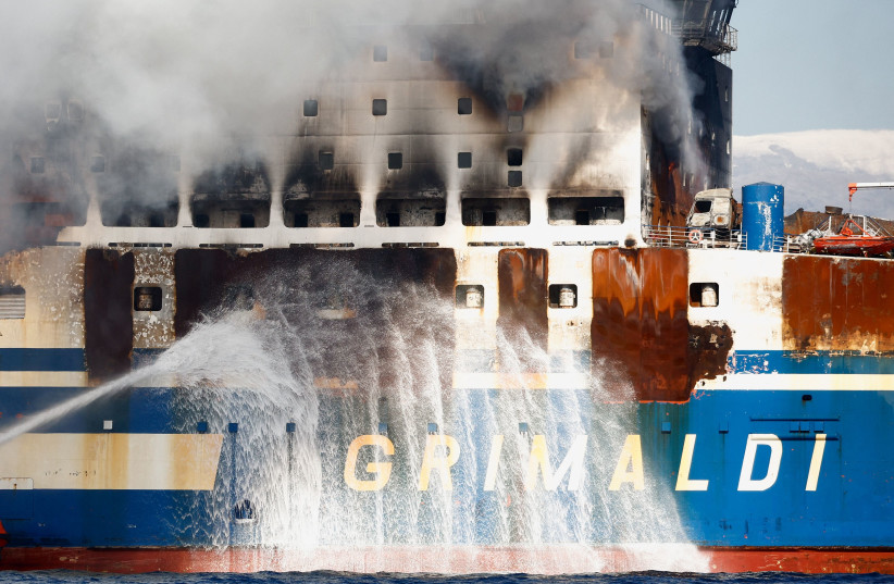  Smoke rises from the Italian-flagged Euroferry Olympia, which sailed from Greece to Italy early on Friday and caught fire, off the coast of Corfu, Greece, February 19, 2022. (credit: REUTERS/GUGLIELMO MANGIAPANE)