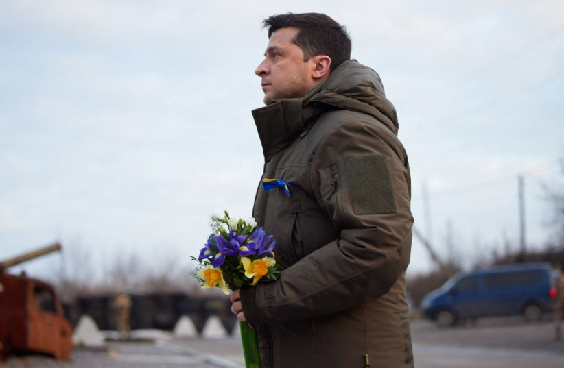 Ukrainian President Volodymyr Zelenskiy visits a memorial to fallen defenders of Ukraine in the Donetsk region, Ukraine February 17, 2022. (credit: Ukrainian Presidential Press Service/Handout via REUTERS)