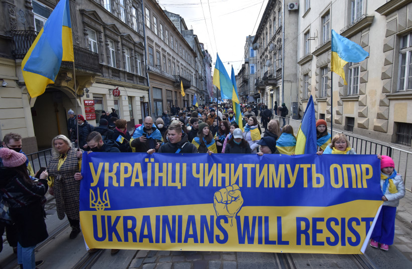  People take part in the Unity March, which is a procession to demonstrate Ukrainians' patriotic spirit amid growing tensions with Russia, in Lviv, Ukraine February 19, 2022. (photo credit: REUTERS/PAVLO PALAMARCHUK)