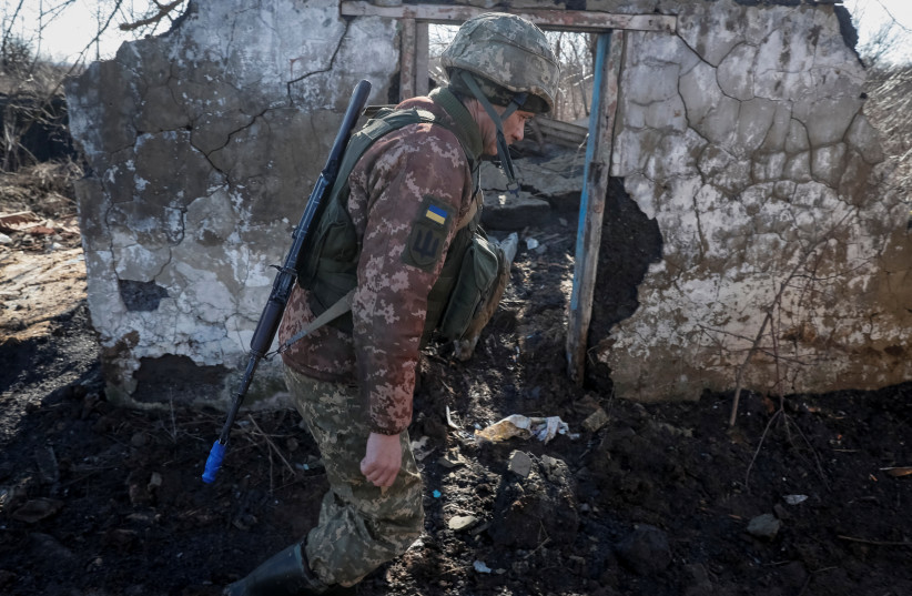  A Ukrainian service member is seen on the front line near the village of Zaitseve in the Donetsk region, Ukraine February 19, 2022. (photo credit: GLEB GARANICH/REUTERS)